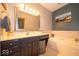 Bathroom with a vanity with hard surface countertops, a bathtub, and modern fixtures at 120 Wagon Trail, Mooresville, IN 46158