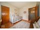 Bright bedroom featuring a daybed, wood floors, and wood trim doors at 120 Wagon Trail, Mooresville, IN 46158