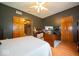 Bedroom showcasing hardwood floors, with dark grey walls and wood trim doors at 120 Wagon Trail, Mooresville, IN 46158