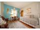 Charming bedroom featuring hardwood floors, a vintage desk, and decorative angel wings at 120 Wagon Trail, Mooresville, IN 46158