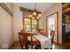 Cozy dining area with wood floors, seating for four, and natural light at 120 Wagon Trail, Mooresville, IN 46158