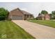 Spacious driveway leading to a well-maintained brick home with lush green lawn at 120 Wagon Trail, Mooresville, IN 46158