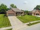 Lovely brick home with an attached two-car garage, a meticulously kept lawn, and vibrant flowerbeds, perfect for a Gathering at 120 Wagon Trail, Mooresville, IN 46158