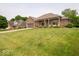 Beautiful brick home with large front yard, covered porch, and well-maintained landscaping at 120 Wagon Trail, Mooresville, IN 46158
