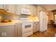 Well-equipped kitchen with white appliances, ample storage, and hardwood floors at 120 Wagon Trail, Mooresville, IN 46158