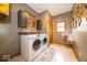 Well-equipped laundry room with modern washer and dryer and ample cabinet space at 120 Wagon Trail, Mooresville, IN 46158