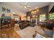 Open living room featuring a fireplace and hardwood floors at 120 Wagon Trail, Mooresville, IN 46158