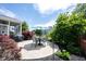 Backyard patio area features a dining set with umbrella, a screened-in porch, and meticulous landscaping at 12093 Ashland Dr, Fishers, IN 46037