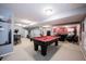 Open finished basement with a pool table, exercise area, and comfortable seating at 12093 Ashland Dr, Fishers, IN 46037