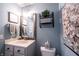 Stylish powder room with wood mirror, granite vanity, and modern accents at 12093 Ashland Dr, Fishers, IN 46037