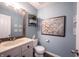 Stylish powder room with wood mirror, granite vanity, and modern accents at 12093 Ashland Dr, Fishers, IN 46037