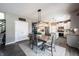 Dining area with table seating, connecting to a modern white kitchen with stainless steel appliances at 12093 Ashland Dr, Fishers, IN 46037
