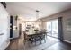Dining room with a wooden table, seating for six, and a view into the modern kitchen at 12093 Ashland Dr, Fishers, IN 46037