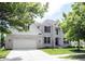 Beautiful two-story home with a brick exterior, well-maintained lawn, and mature trees, creating a welcoming and picturesque setting at 12093 Ashland Dr, Fishers, IN 46037
