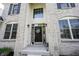 Elegant front door with stylish accents, ample lighting, and meticulous landscaping, creating an inviting and sophisticated entrance at 12093 Ashland Dr, Fishers, IN 46037