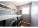 Clean, modern laundry room with stainless steel washer and dryer and granite countertops at 12093 Ashland Dr, Fishers, IN 46037