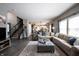Spacious living room with a large sectional, gray ottoman, and an open layout to the rest of the home at 12093 Ashland Dr, Fishers, IN 46037