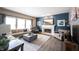 Well-lit living room featuring a cozy fireplace, a large sectional, and modern furnishings at 12093 Ashland Dr, Fishers, IN 46037