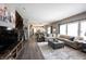 Open-concept living room with a sectional sofa, stairs, and access to the kitchen and dining area at 12093 Ashland Dr, Fishers, IN 46037