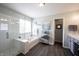 Spa-like main bath featuring a large soaking tub, a walk-in shower, and a door to the outside at 12093 Ashland Dr, Fishers, IN 46037