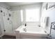 Bright, spa-like bathroom featuring a large soaking tub, a walk-in shower, and a window at 12093 Ashland Dr, Fishers, IN 46037