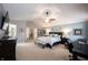 Spacious Primary bedroom with a ceiling fan, a bed, and an attached sitting area with a tv at 12093 Ashland Dr, Fishers, IN 46037
