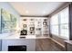 Bright home office featuring custom built-in shelving, modern desk, and natural light, creating a comfortable and productive workspace at 12093 Ashland Dr, Fishers, IN 46037