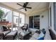 Screened-in porch with cozy seating, ceiling fan, and access to sliding door at 12093 Ashland Dr, Fishers, IN 46037