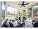 Inviting screened-in porch with wicker furniture and a view of the backyard at 12093 Ashland Dr, Fishers, IN 46037