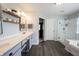 Bright vanity space with double sinks, a makeup area, and an entry into the glass shower at 12093 Ashland Dr, Fishers, IN 46037