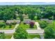 Aerial view of suburban homes with mature trees, landscaped yards, and neighborhood streets at 1219 Driftwood Dr, Carmel, IN 46033