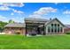 Expansive backyard featuring a covered patio, lush lawn, and attractive landscaping at 1219 Driftwood Dr, Carmel, IN 46033