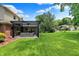 Landscaped backyard featuring a covered patio with outdoor seating at 1219 Driftwood Dr, Carmel, IN 46033