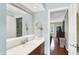 Bright bathroom with modern vanity, framed mirror, wall mounted cosmetic mirror, and neutral wall paint at 1219 Driftwood Dr, Carmel, IN 46033