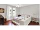 Neutral bedroom featuring hardwood floors, two windows, linen curtains, and a ceiling fan at 1219 Driftwood Dr, Carmel, IN 46033