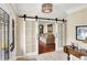Entry with tile flooring, sliding barn doors, and a view into the living room at 1219 Driftwood Dr, Carmel, IN 46033