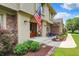 Beautiful front porch with a vibrant American flag, landscaped garden, and charming seating area at 1219 Driftwood Dr, Carmel, IN 46033