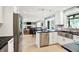 Open-concept kitchen with stainless steel appliances and views into the adjacent dining and living areas at 1219 Driftwood Dr, Carmel, IN 46033