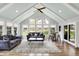 Bright sunroom with vaulted ceilings, lots of windows, hardwood floors, and comfortable seating at 1219 Driftwood Dr, Carmel, IN 46033