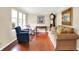 Bright living room with hardwood floors, sofa, area rug, and decorative artwork at 1219 Driftwood Dr, Carmel, IN 46033
