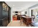 Bright living room with wooden floors, a black cabinet, and an airy feel looking to an adjacent area at 1219 Driftwood Dr, Carmel, IN 46033