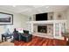 Inviting living room featuring a stone fireplace with a mantel, custom built-ins, and comfortable seating at 1219 Driftwood Dr, Carmel, IN 46033