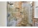 Shower features decorative tile, glass doors, niche, rain shower head, and hand held shower attachment at 1219 Driftwood Dr, Carmel, IN 46033