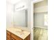 Bright bathroom featuring an expansive mirror and vanity with natural stone at 12289 Charing Cross Rd, Carmel, IN 46033