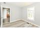 An airy bedroom features modern flooring, a bright window and views to kitchen at 12289 Charing Cross Rd, Carmel, IN 46033