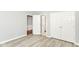 A bright bedroom features wood-look flooring, light grey walls, and double closets at 12289 Charing Cross Rd, Carmel, IN 46033