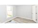 Sunlit bedroom featuring wood-look flooring and a bright window with backyard views at 12289 Charing Cross Rd, Carmel, IN 46033