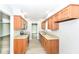 Galley kitchen featuring wood cabinets, granite countertops, and stainless steel appliances at 12289 Charing Cross Rd, Carmel, IN 46033