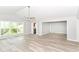 Open-concept living room featuring hardwood floors, a ceiling fan, and ample natural light at 12289 Charing Cross Rd, Carmel, IN 46033