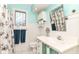 Charming bathroom with wainscoting, stained glass, and a decorative mirror at 13017 Water Ridge Dr, McCordsville, IN 46055